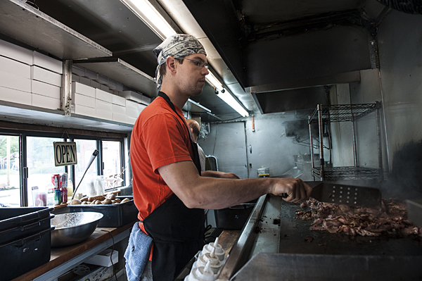 Andrew Heimburger, executive chef at the Local Pig food truck cooks up beef shortrib pastrami for tomato sandwiches.